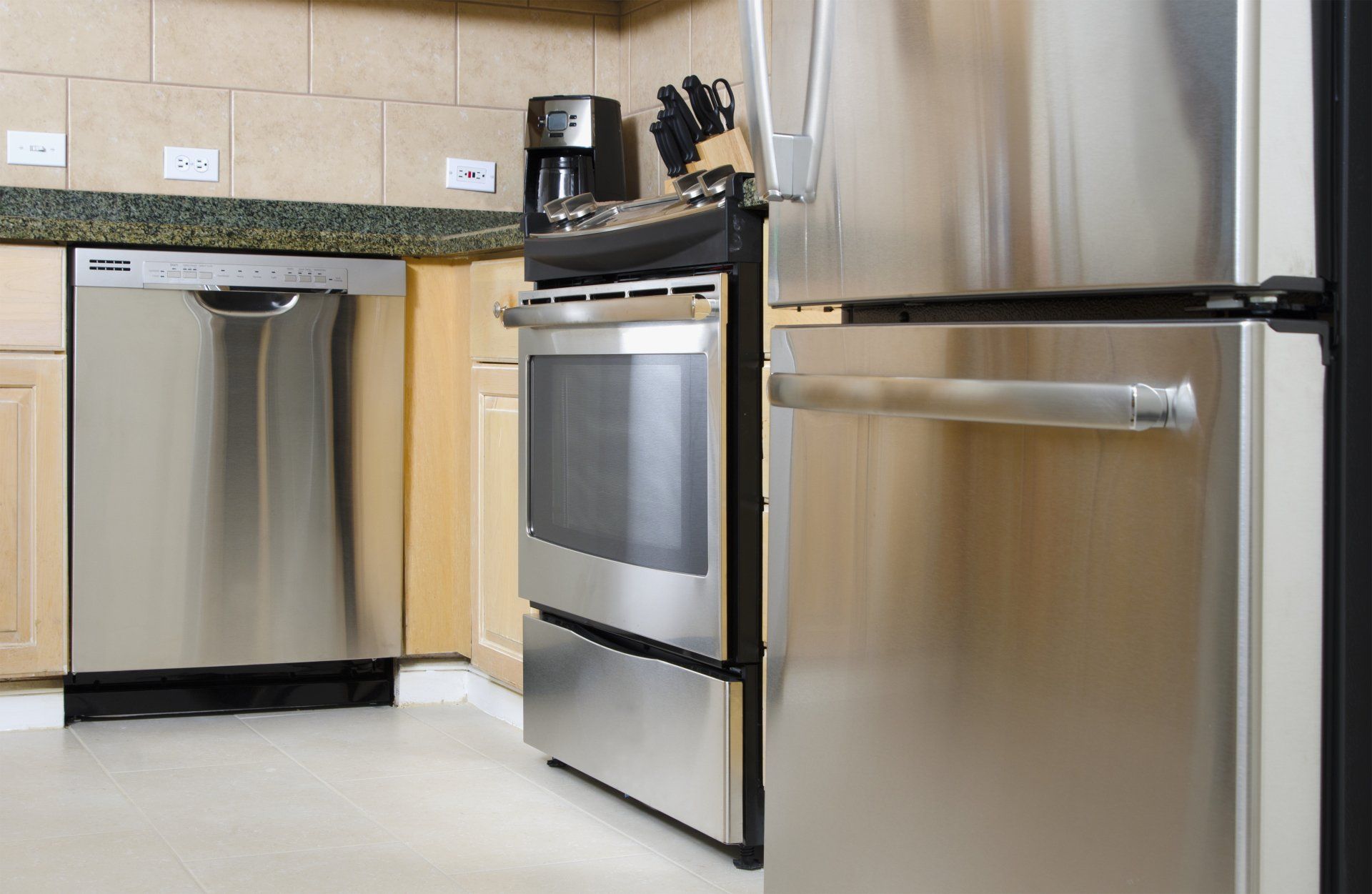 A kitchen with stainless steel appliances including a refrigerator stove and dishwasher