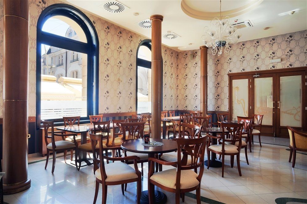A restaurant with a lot of tables and chairs. Devine Shine Window Cleaning Canton MI.