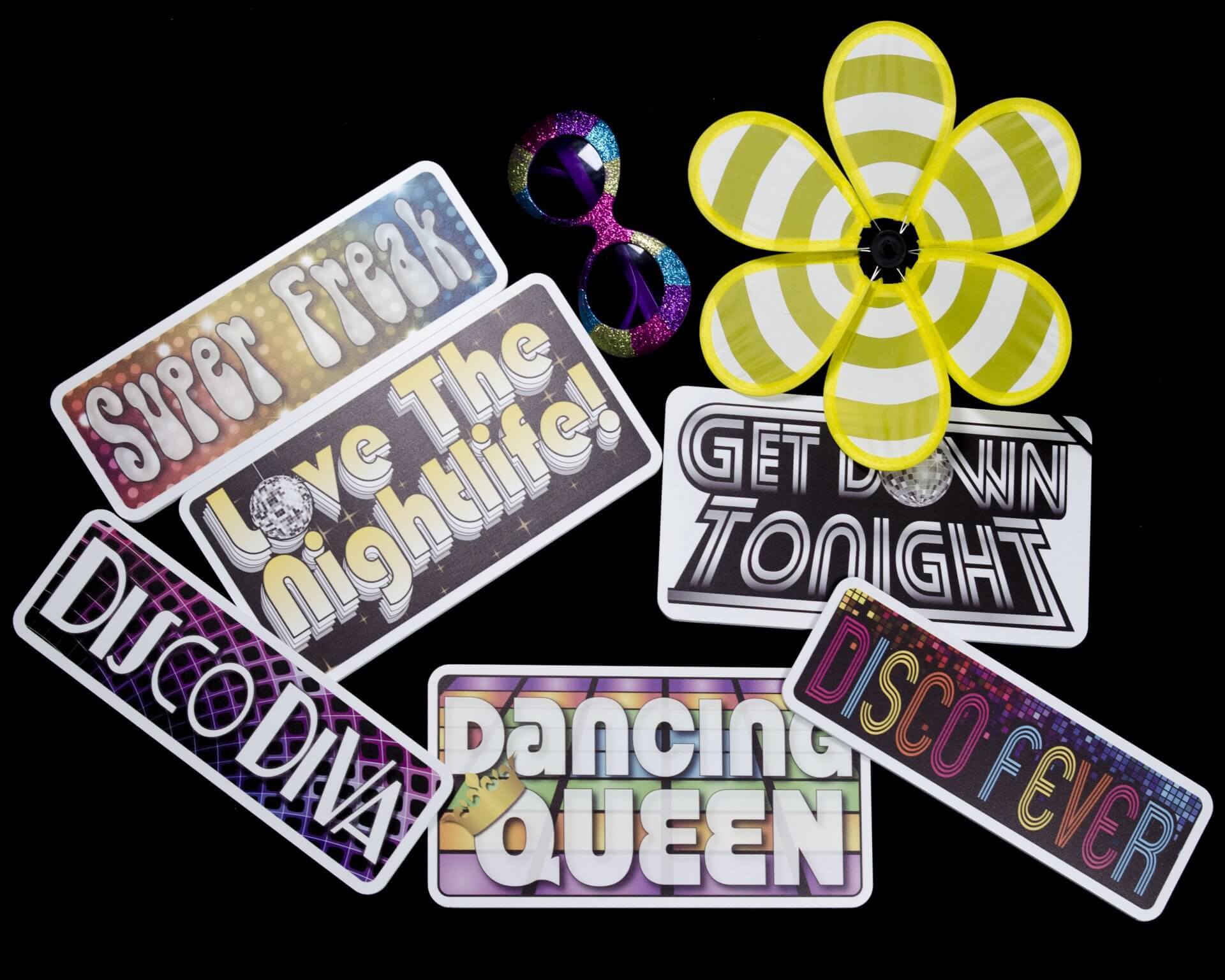 Disco-themed party props: signs with phrases like 