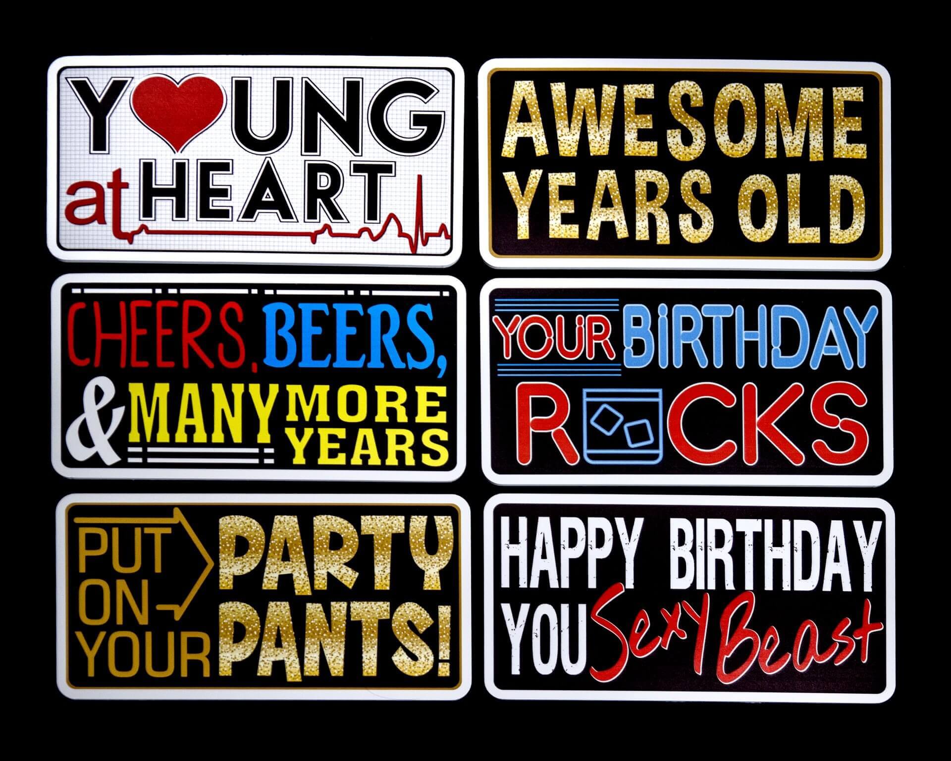Six birthday-themed signs with various phrases like 