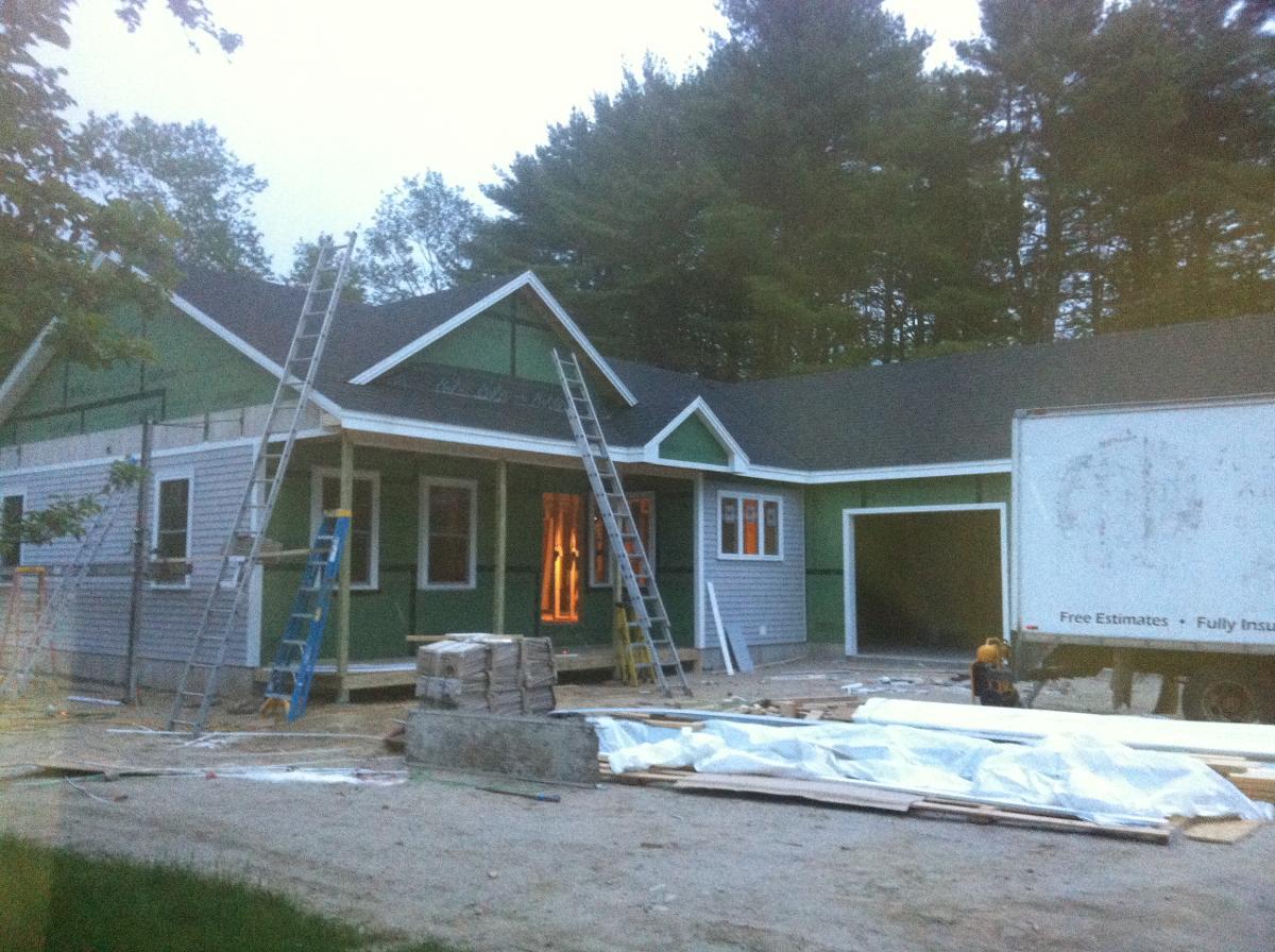 Multiple ladders resting against Scarborough, ME home