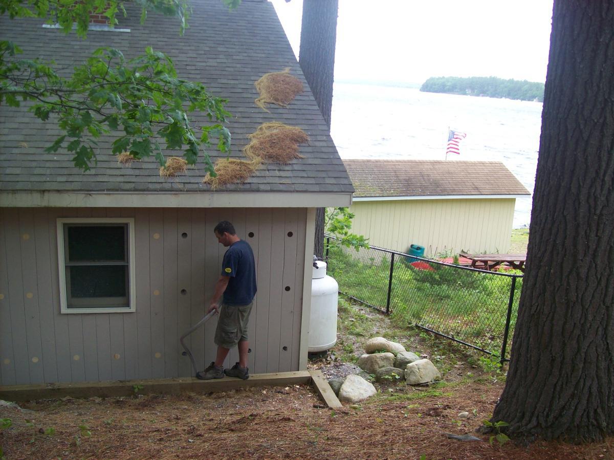 Spray foam insulation being added to cabin near the water