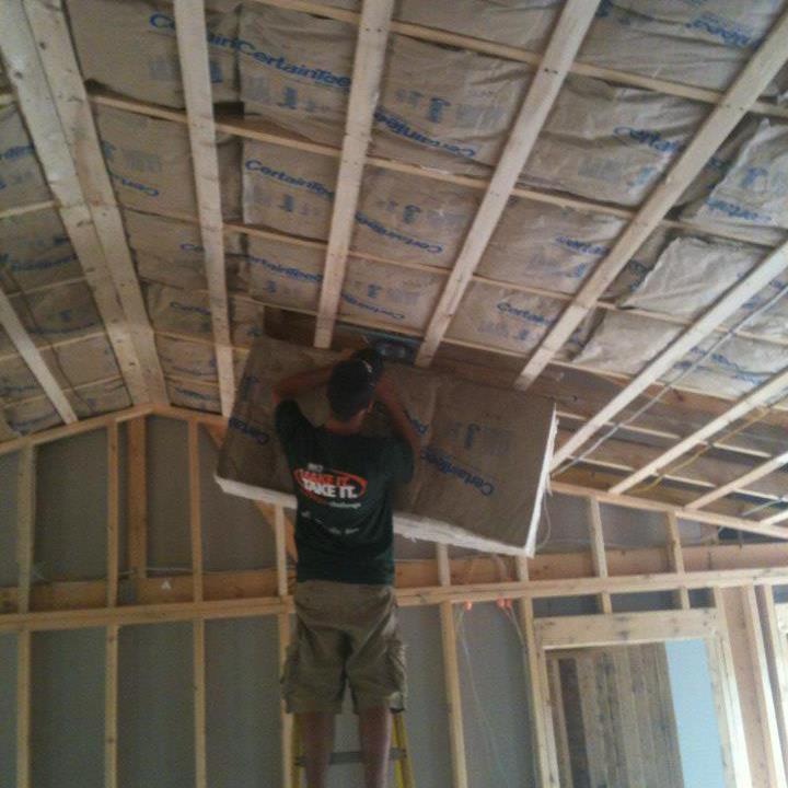 Fiberglass insulation being installed in ceiling of Windham, ME home