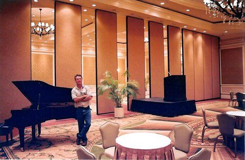 Man in a Event Hall with Piano — Miami, FL — Folding Walls Of Miami Inc