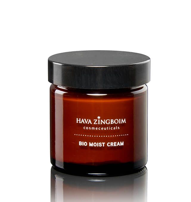 A brown jar of bio moist cream is sitting on a white surface.