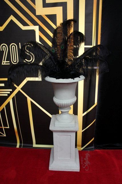 Urn with large ostrich feather