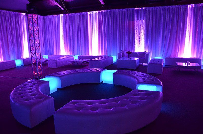 Purple wall wash lights under white chiffon drapes