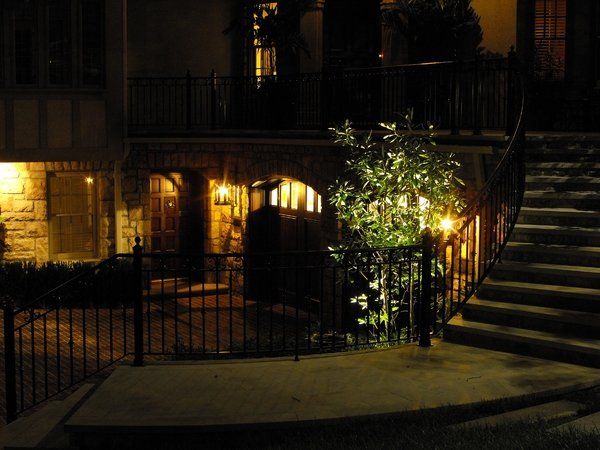 A house with stairs leading up to it is lit up at night