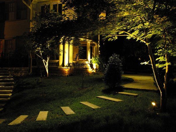 The front of a house is lit up at night