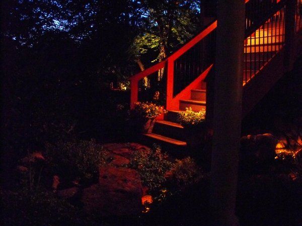 A red staircase is lit up at night