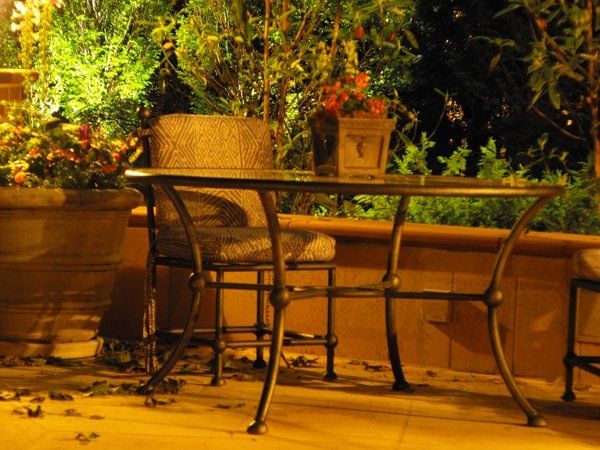 A table and chairs on a patio at night