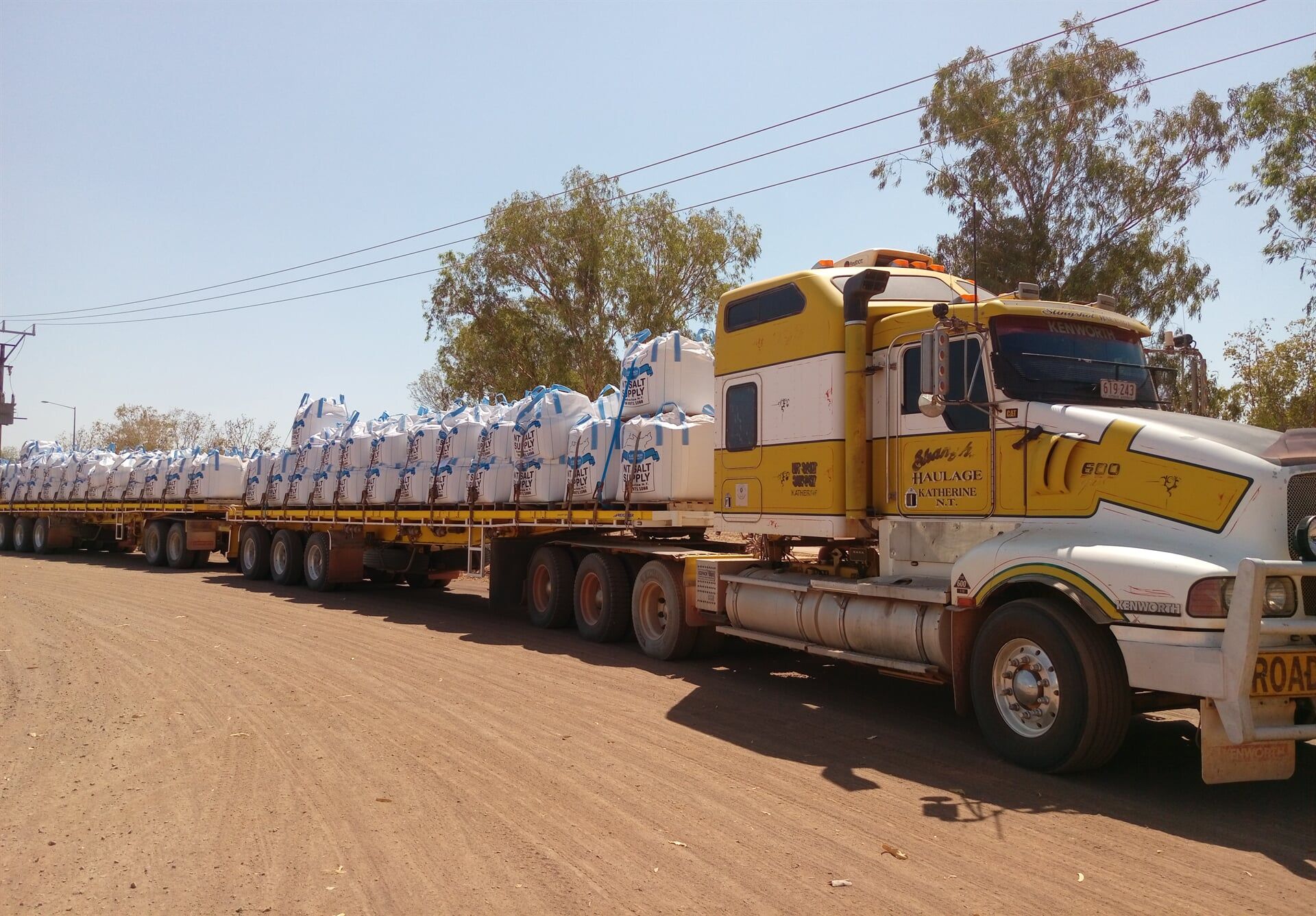 A yellow and white semi truck with the number 77 on the side- Slingshot Haulage in Katherine, NT