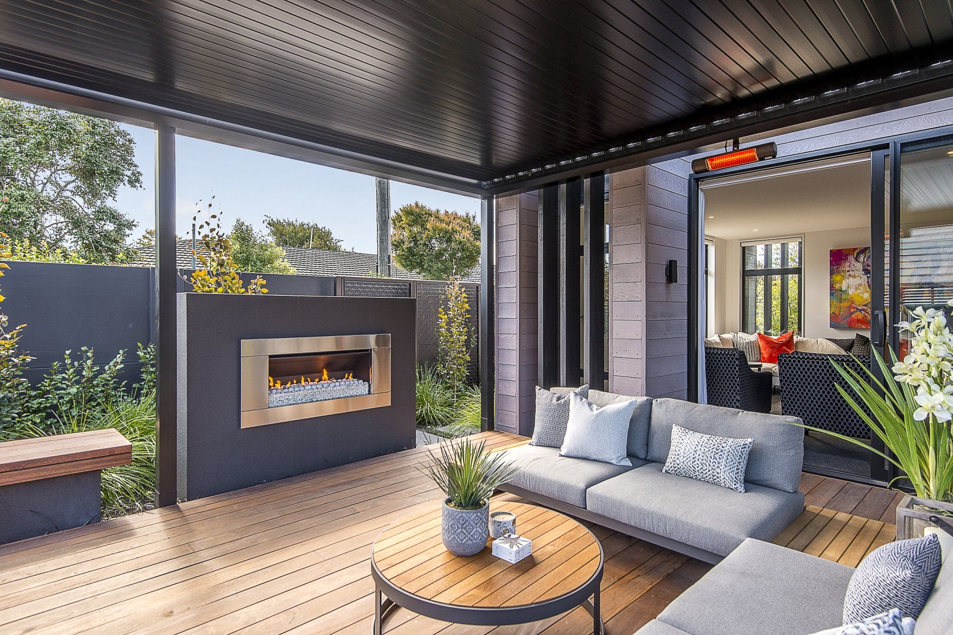A living room with a couch , table and fireplace.