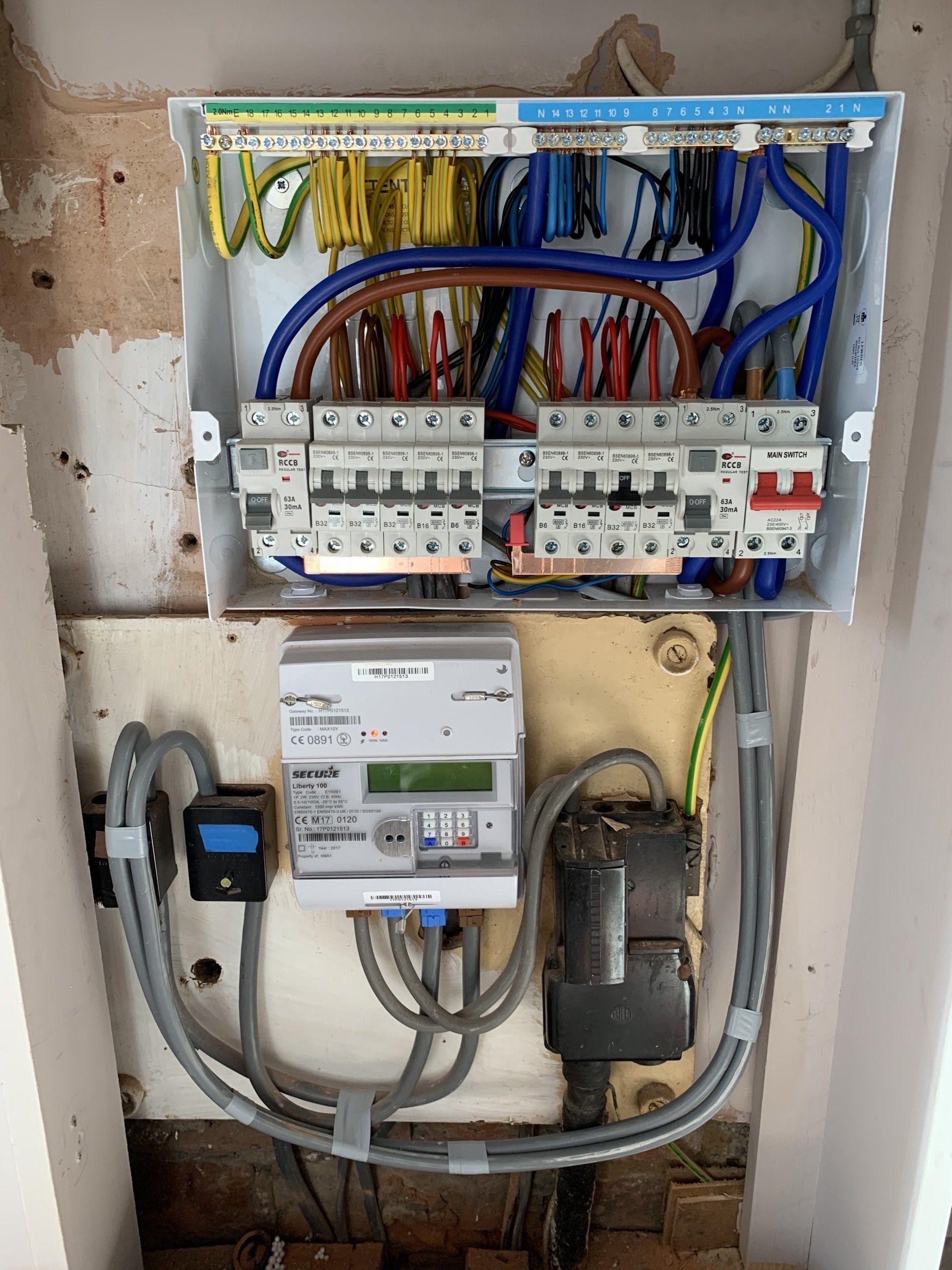 A electrical box with a lot of wires coming out of it.