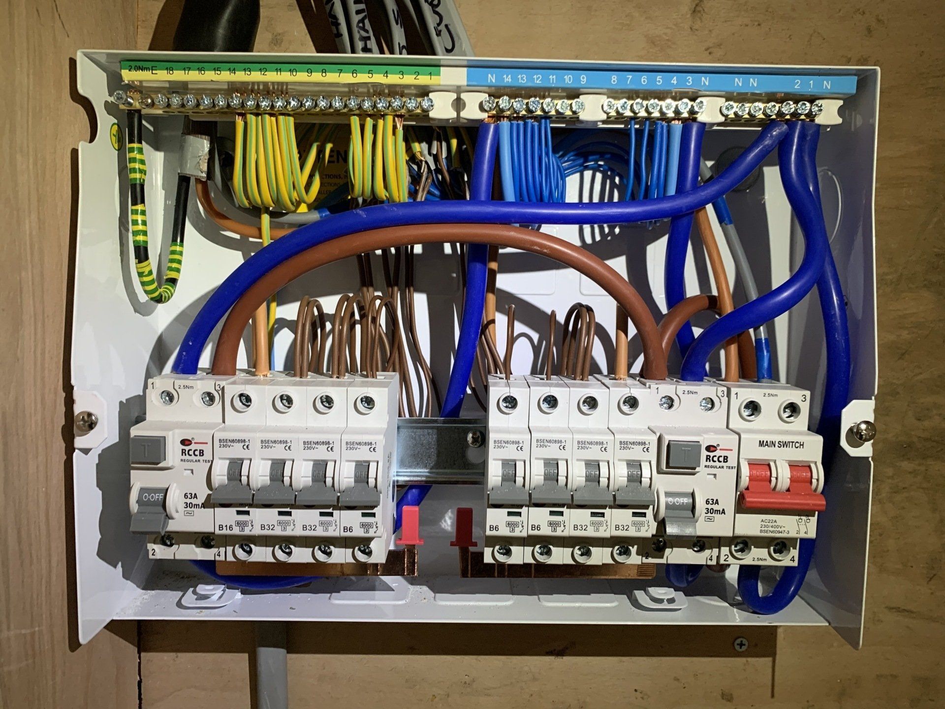 A white box with a bunch of wires coming out of it