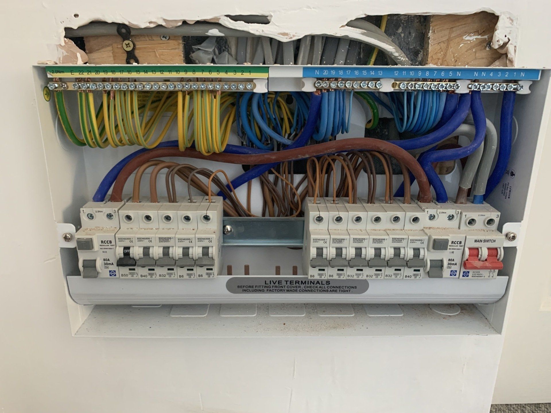 A close up of a electrical box with a lot of wires coming out of it.
