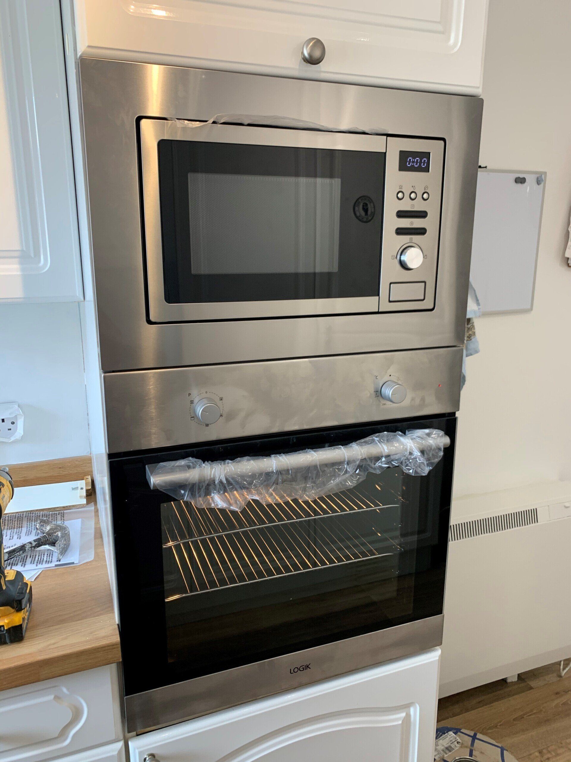 A stainless steel oven with a microwave inside of it