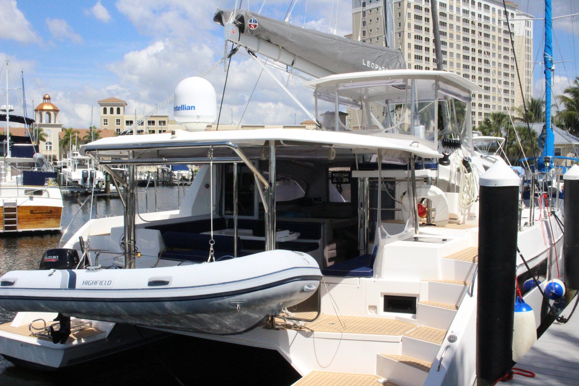 A boat with a raft attached to it is docked in a marina.
