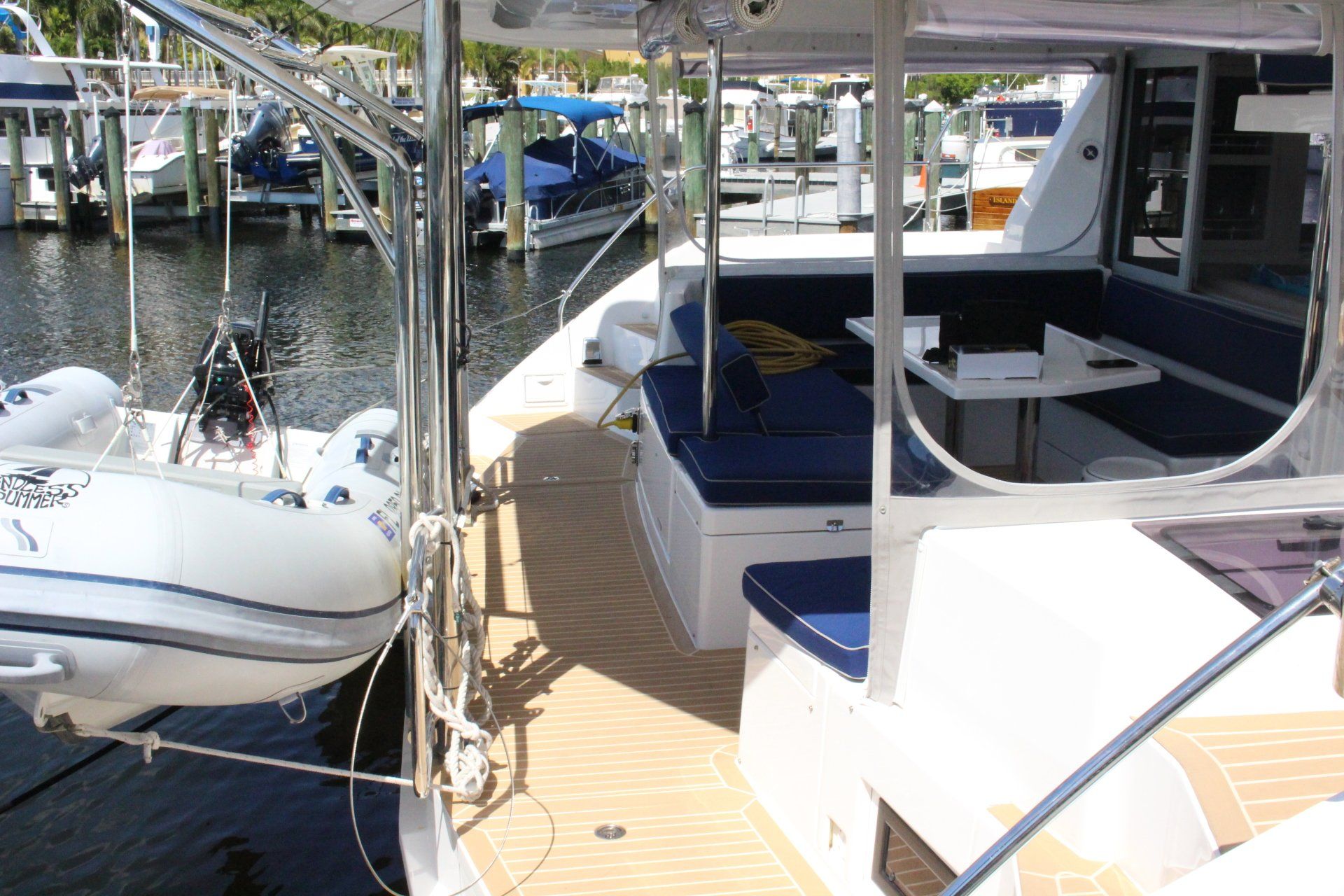A boat is docked in a marina and has a table on the deck