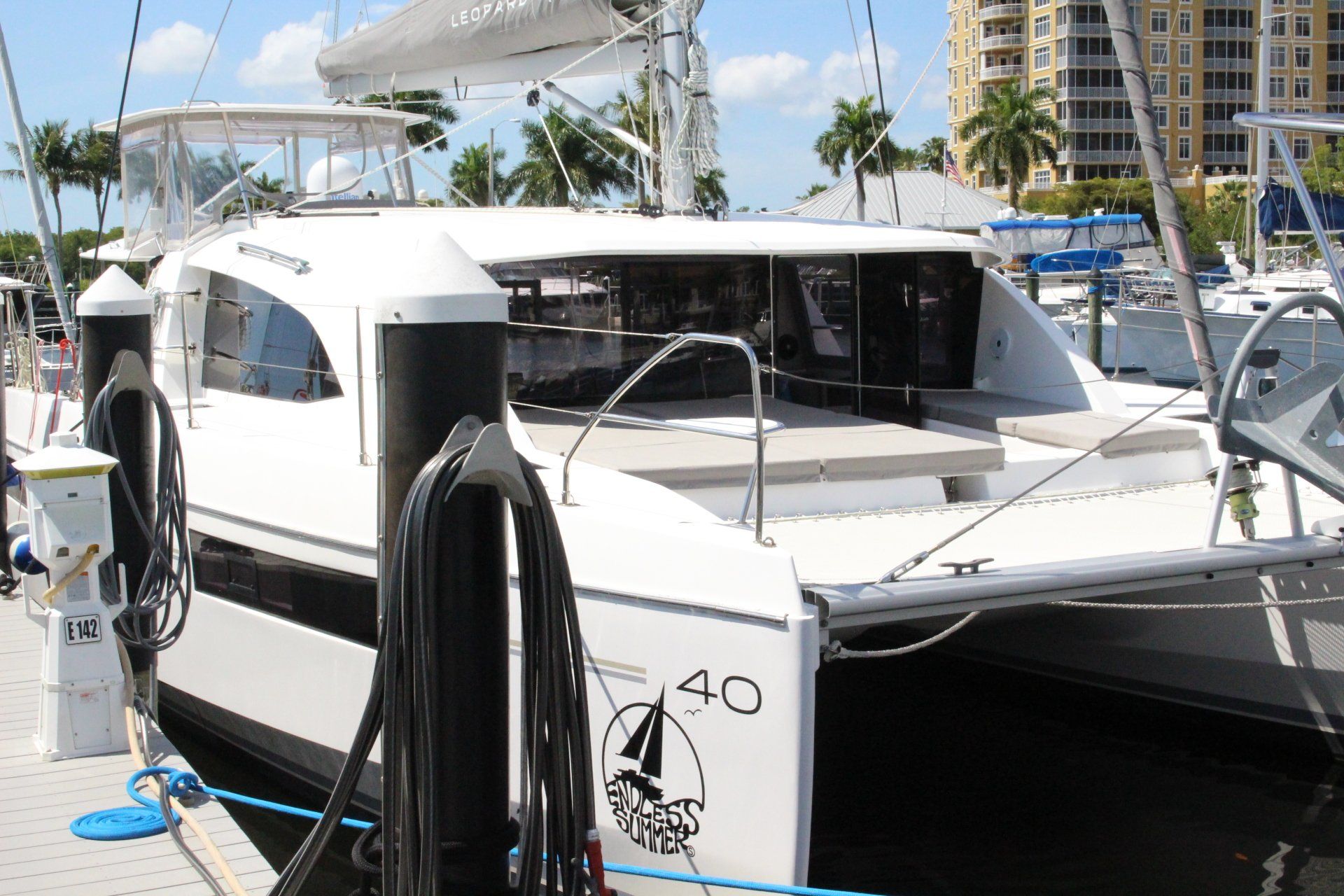 A white boat with the number 40 on the side is docked at a marina