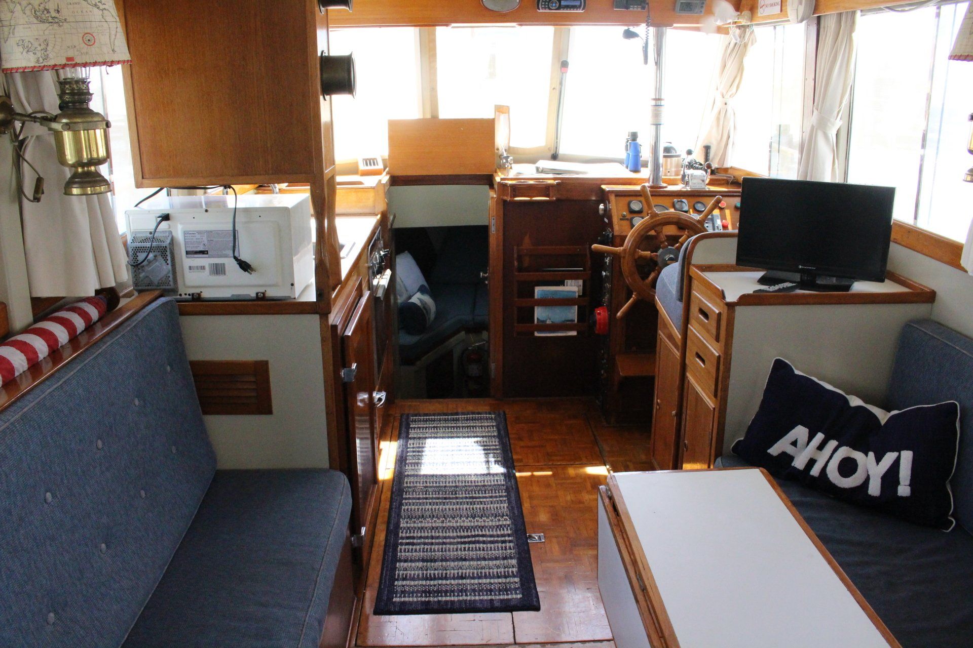 The inside of a boat with a pillow that says ahoy