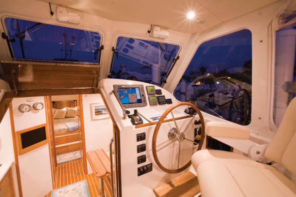 The inside of a boat with a steering wheel