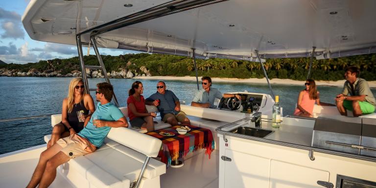 A group of people are sitting on a boat in the water.