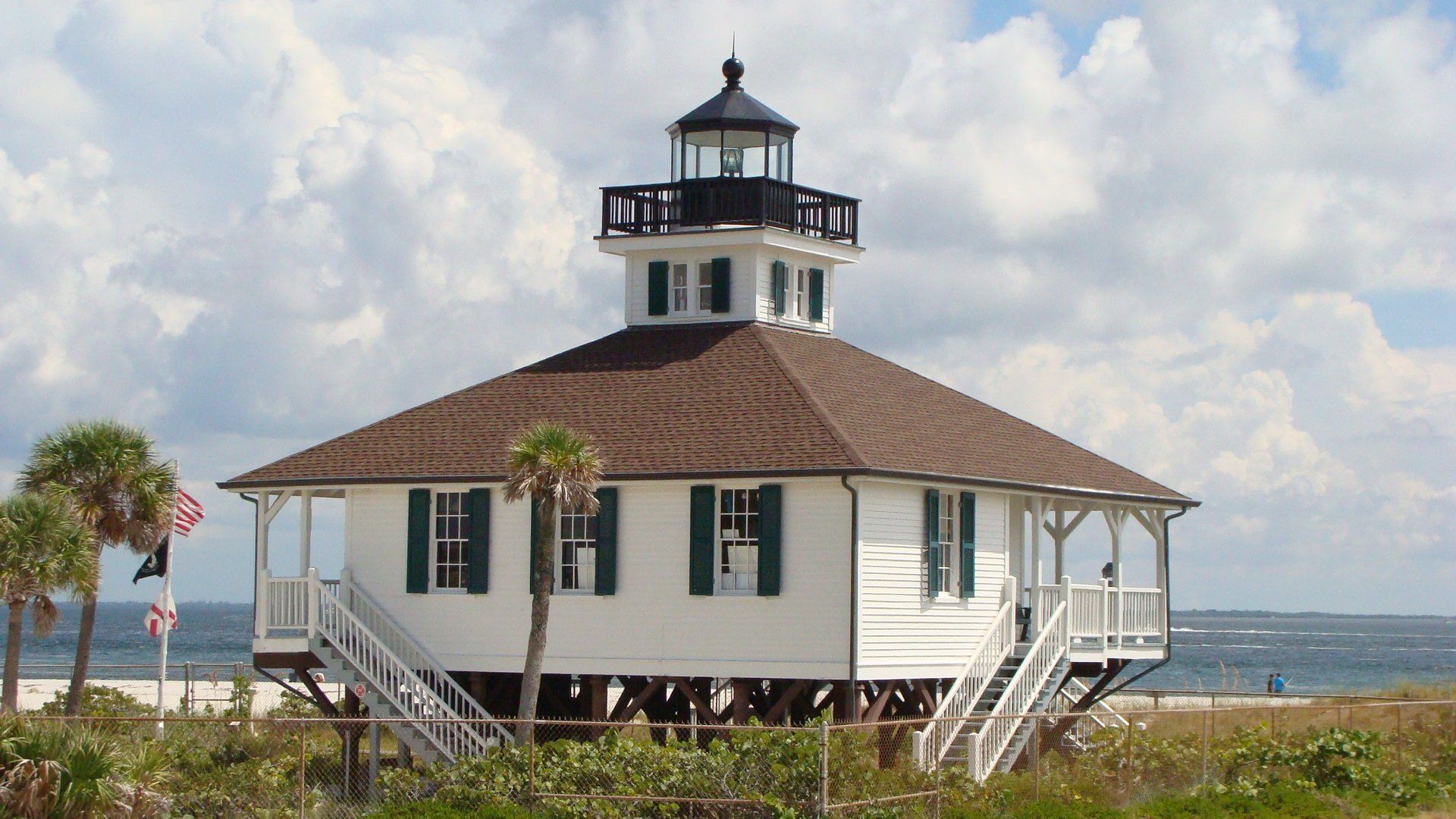A white house with a lighthouse on top of it