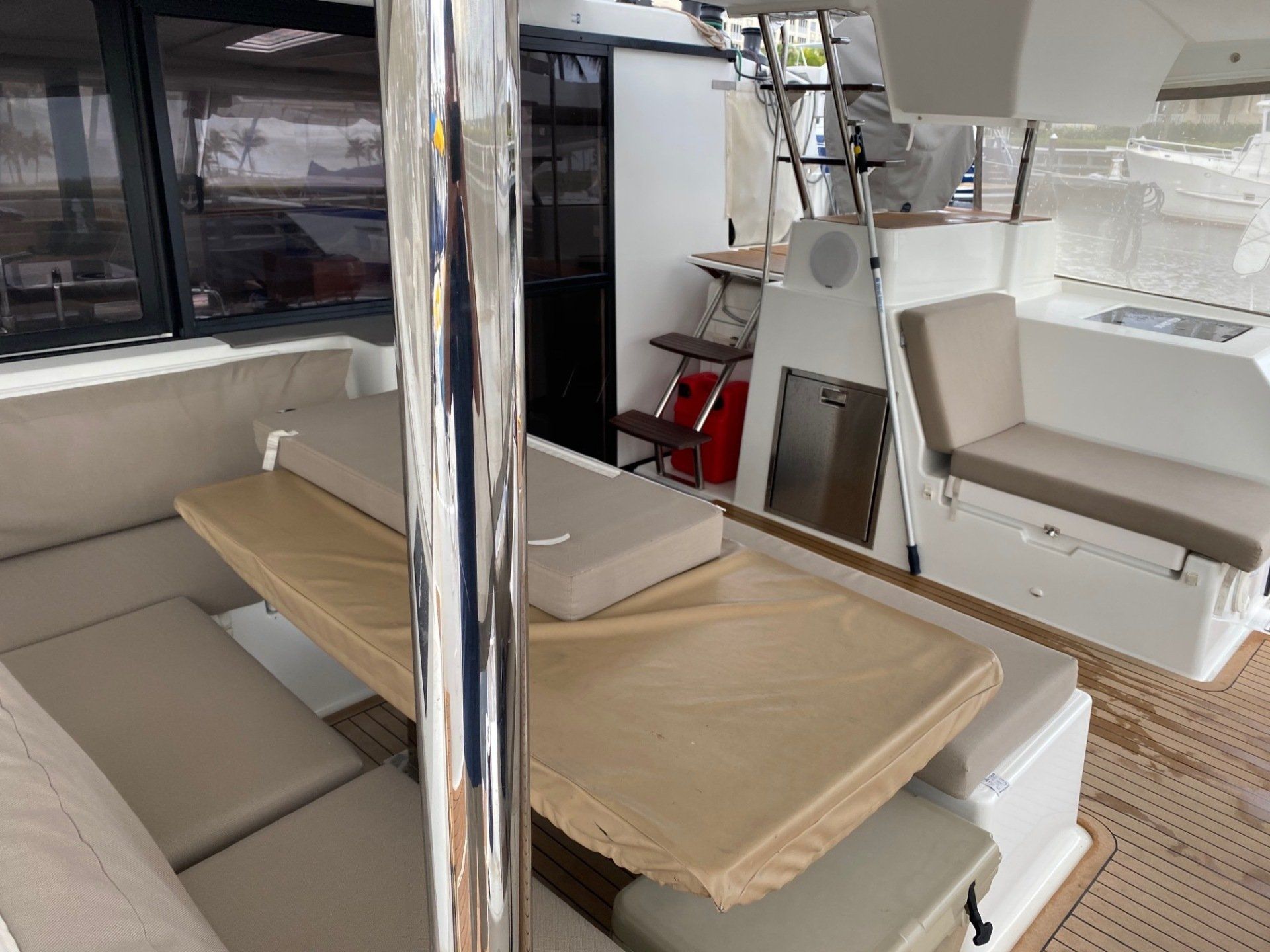 The inside of a boat with a table and chairs.