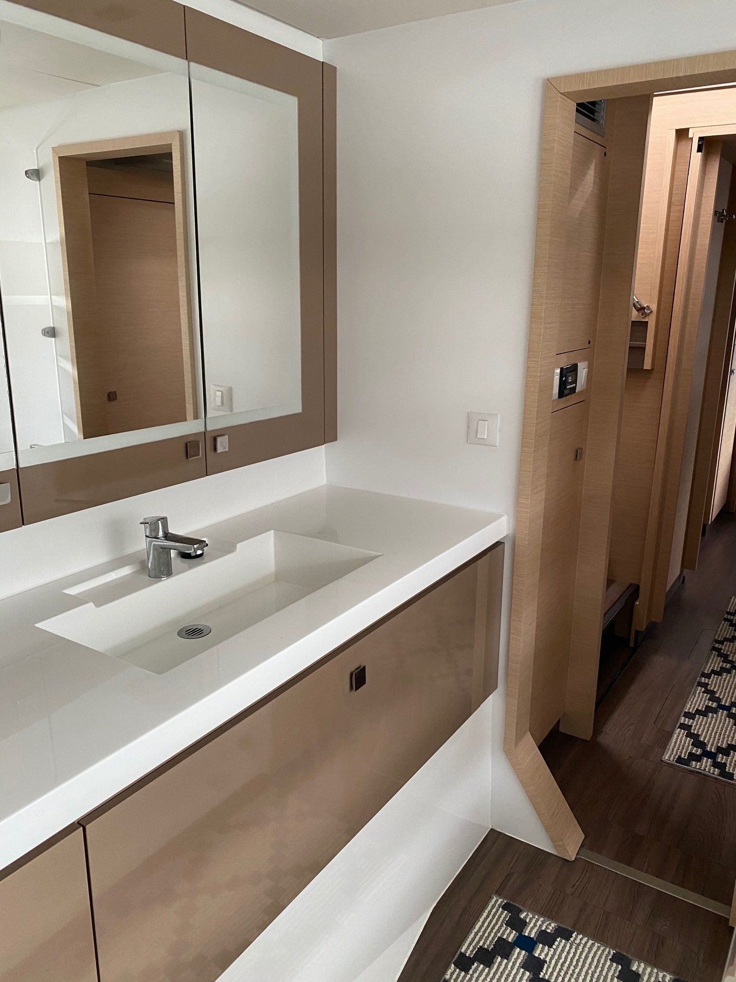 A bathroom with a sink , mirror and cabinets