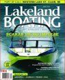 A green boat is on the cover of a lakeland boating magazine.