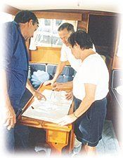 A group of people are looking at a map on a boat.