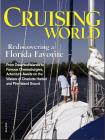 A couple of people standing on top of a sailboat.