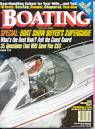 A man is driving a boat on the cover of a boating magazine.