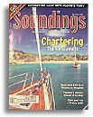 A boat is on the cover of a magazine called soundings chartering.