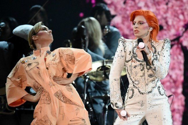 A couple of women are standing next to each other on a stage.