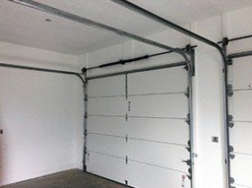 Man pressing garage switch — Electric garage door in Harrisonville, MO Man pressing garage switch — Electric garage door in Harrisonville, MO