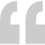 A pair of gray quotation marks on a white background.