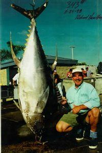 Seafood Wholesale - Man smiling next to a big fish in San Diego, CA