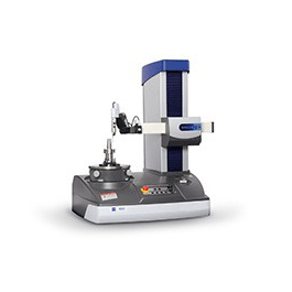 A machine is sitting on top of a table on a white background.