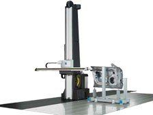 A machine is sitting on a table with a piece of metal on it.