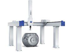 A large machine is sitting on top of a table next to a ball.