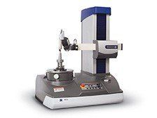 A machine is sitting on top of a table on a white background.