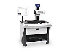 A machine is sitting on top of a table on a white background.