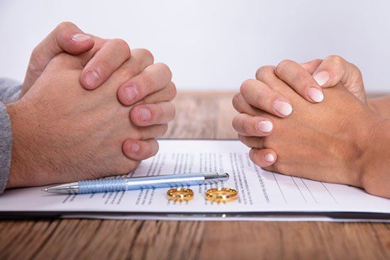 Couple's Hand with Divorce Agreement — Sand Pedro, CA — Delta Bravo Group Couple's Hand with Divorce Agreement — Sand Pedro, CA — Delta Bravo Group