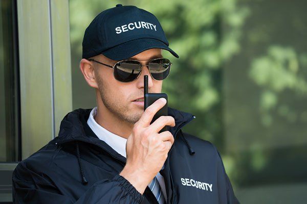 Security Guard Talking on Walkie-Talkie — Sand Pedro, CA — Delta Bravo Group Security Guard Talking on Walkie-Talkie — Sand Pedro, CA — Delta Bravo Group