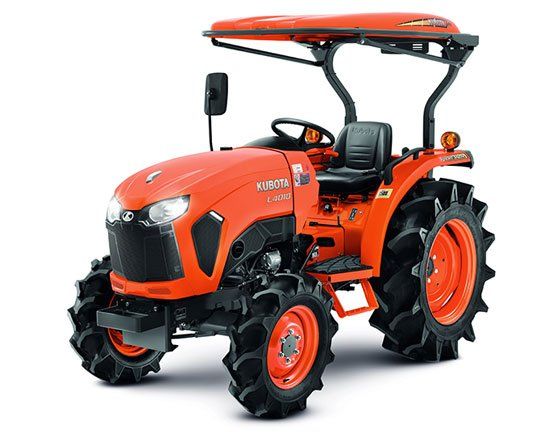 Orange compact tractor with canopy and black tires, shown on a white background