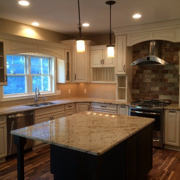 A kitchen with a large island in the middle