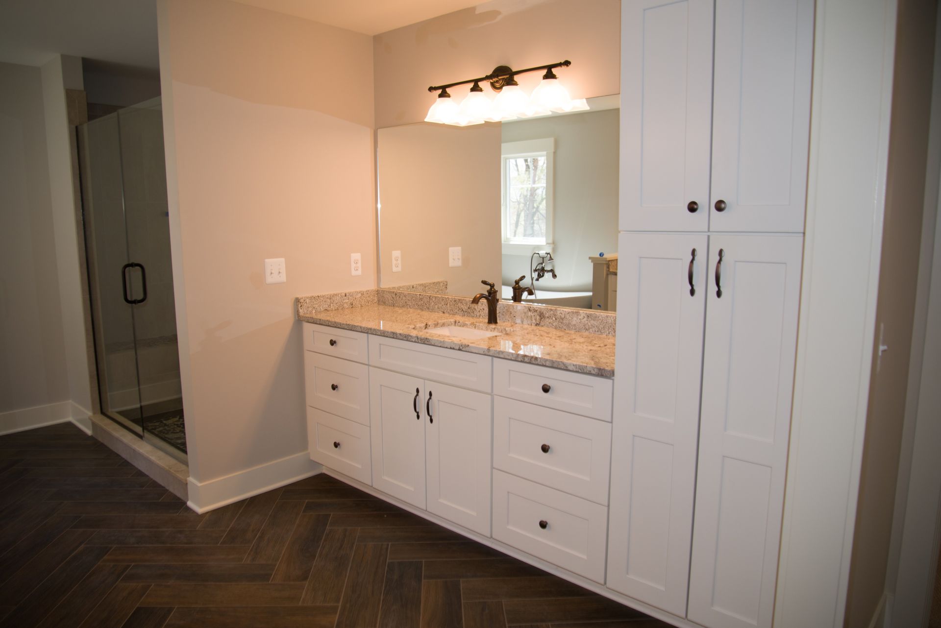 A bathroom with two sinks and a large mirror.
