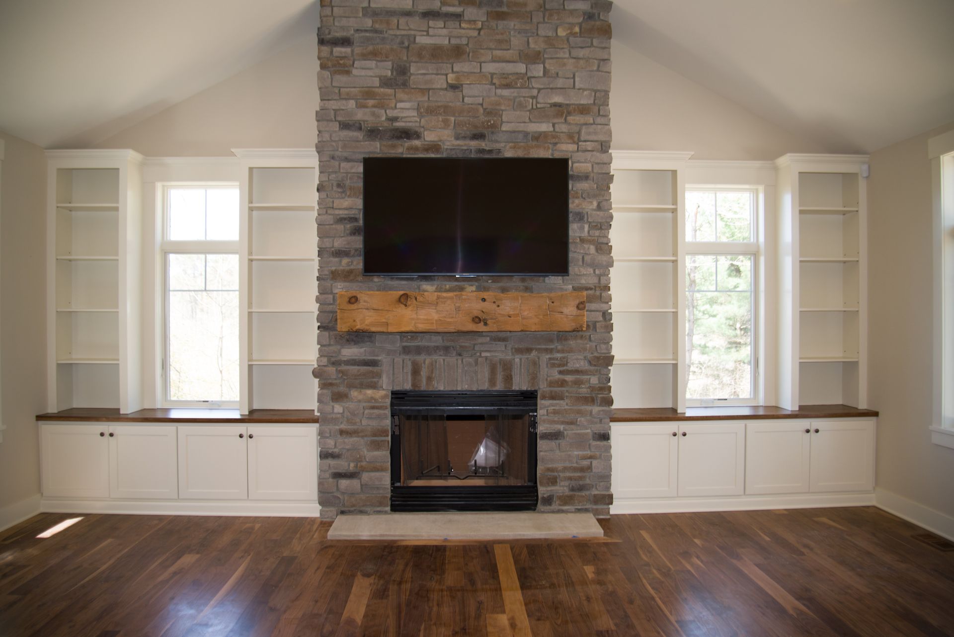 A living room with a fireplace and a flat screen tv